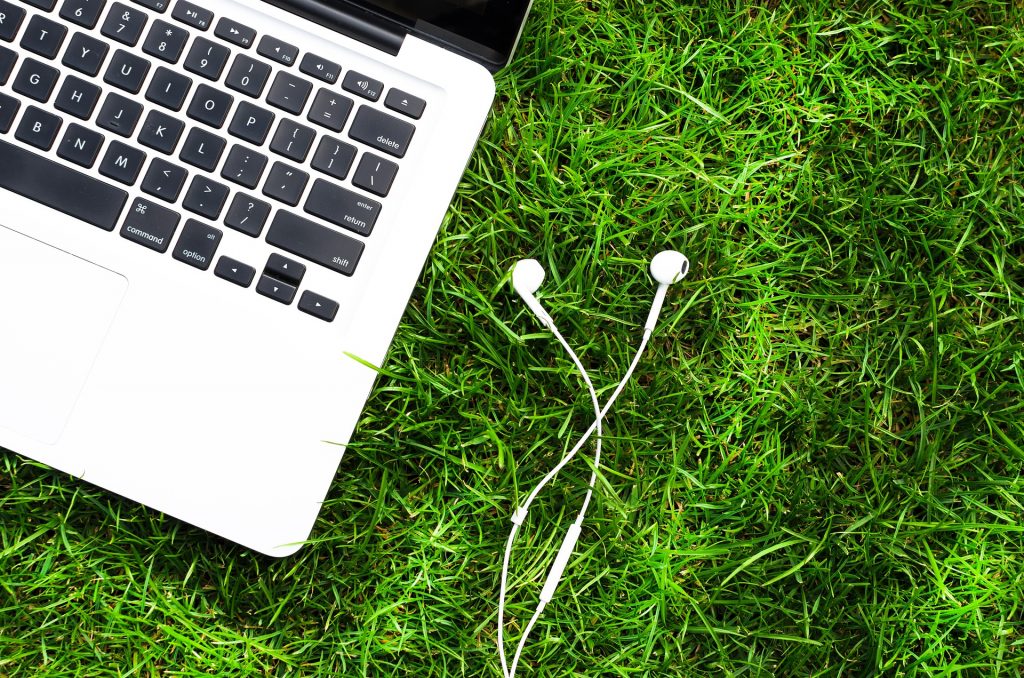 A Mac on a field of grass. Gig work - where independent contractors - work from anywhere in the world - is on the rise.