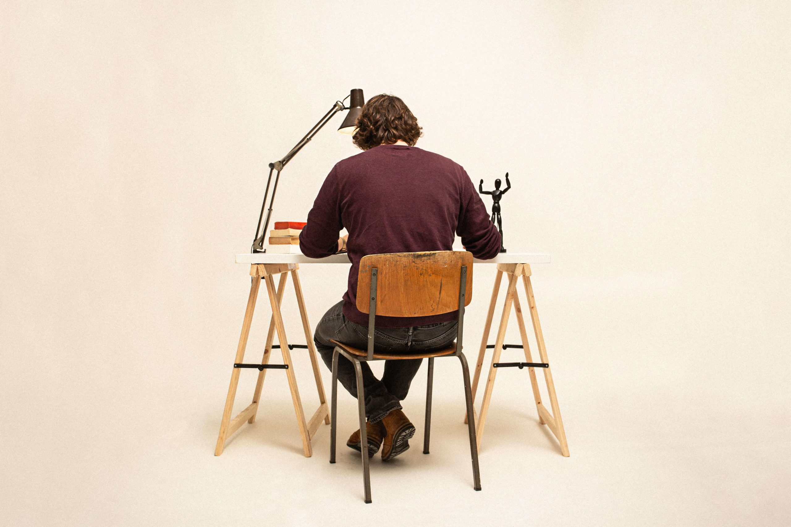 man sitting at desk back facing camera