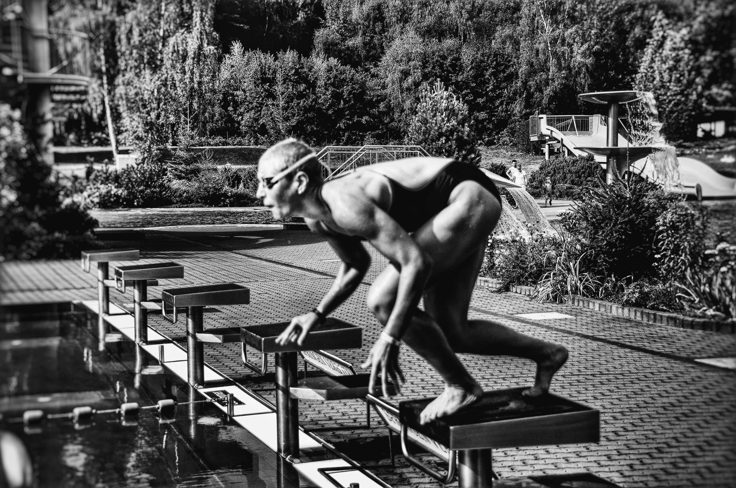 swimmer jumping into pool